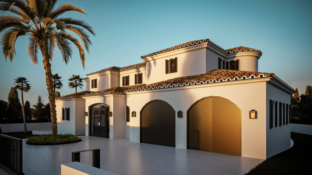 The image shows a Mediterranean-style villa with smooth white stucco walls and terracotta roof tiles. The house features multiple arched windows and doors, with one prominent rounded turret-like section that includes a balcony with wrought iron railings. The villa has a spacious outdoor patio area with steps leading up to it and is surrounded by greenery, including a few palm trees in the background. The overall design is elegant and luxurious, highlighting a blend of traditional Mediterranean and modern architectural elements